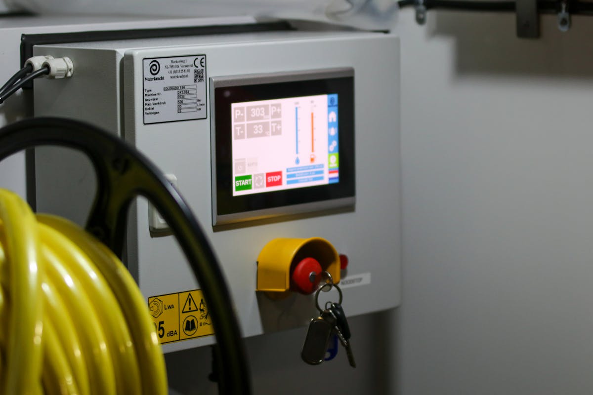 Industrial control panel with HMI screen and emergency stop